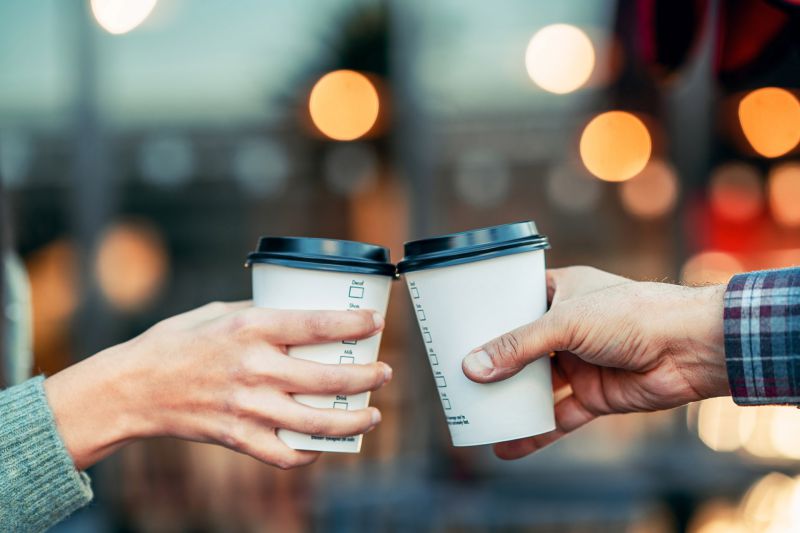 Two Hands holding Coffee Cups